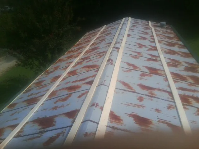 Rusted metal roof panels with new wood purlins before replacement — Storm Damage Roof Repair in Valatie by Roofing Brothers